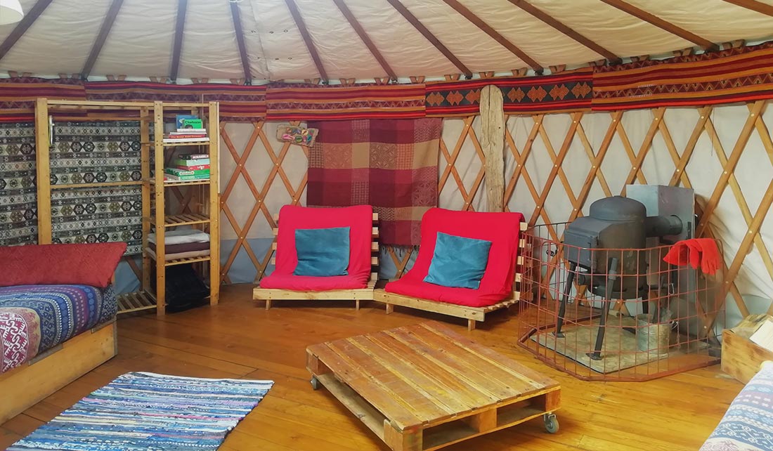 Panoramic view of inside of Yurt seating and sleeping area
