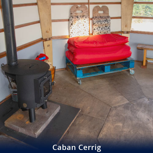 Caban Cerrig inside vide of wood burning stove and seating area